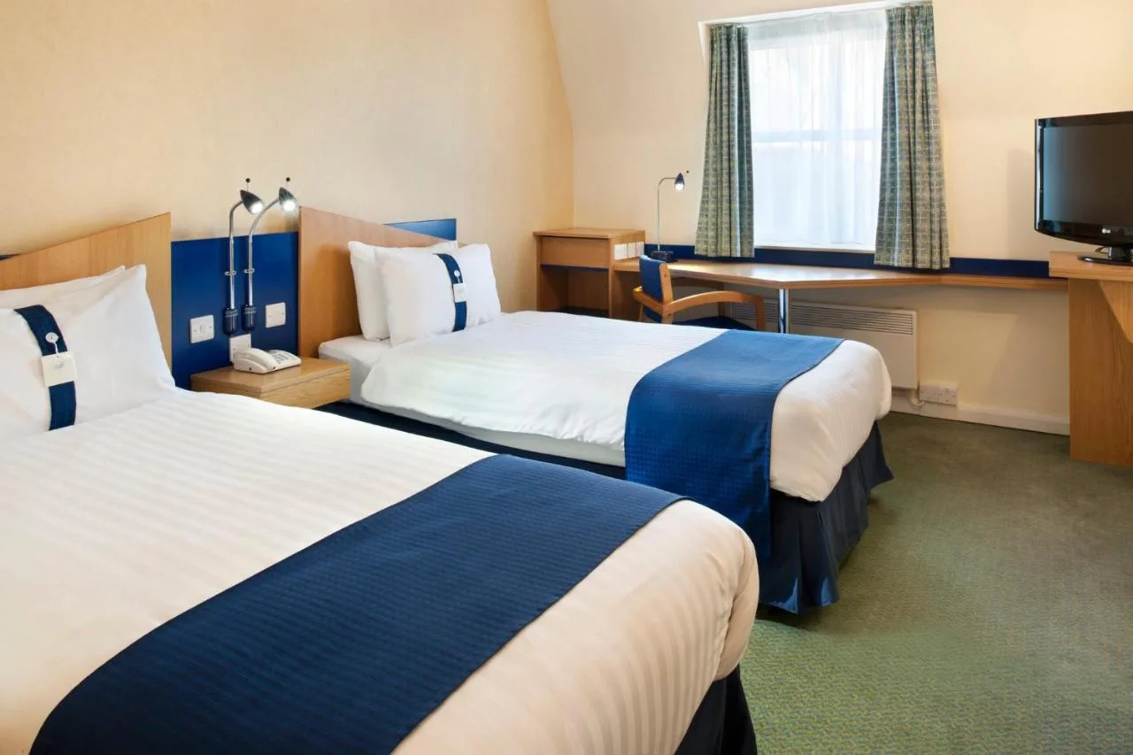 a hotel room with two beds and a television at Holiday Inn Express Aberdeen City Centre by IHG in Aberdeen