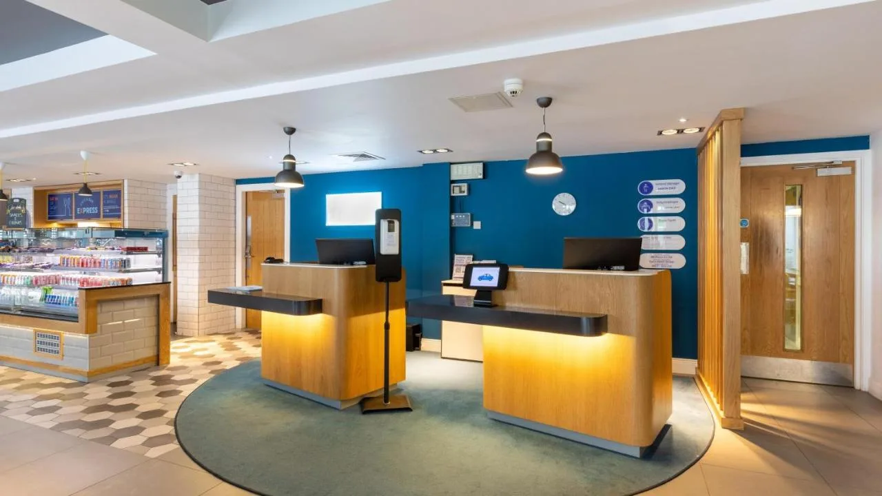 a store with blue walls and wooden counters at Holiday Inn Express Aberdeen City Centre by IHG in Aberdeen